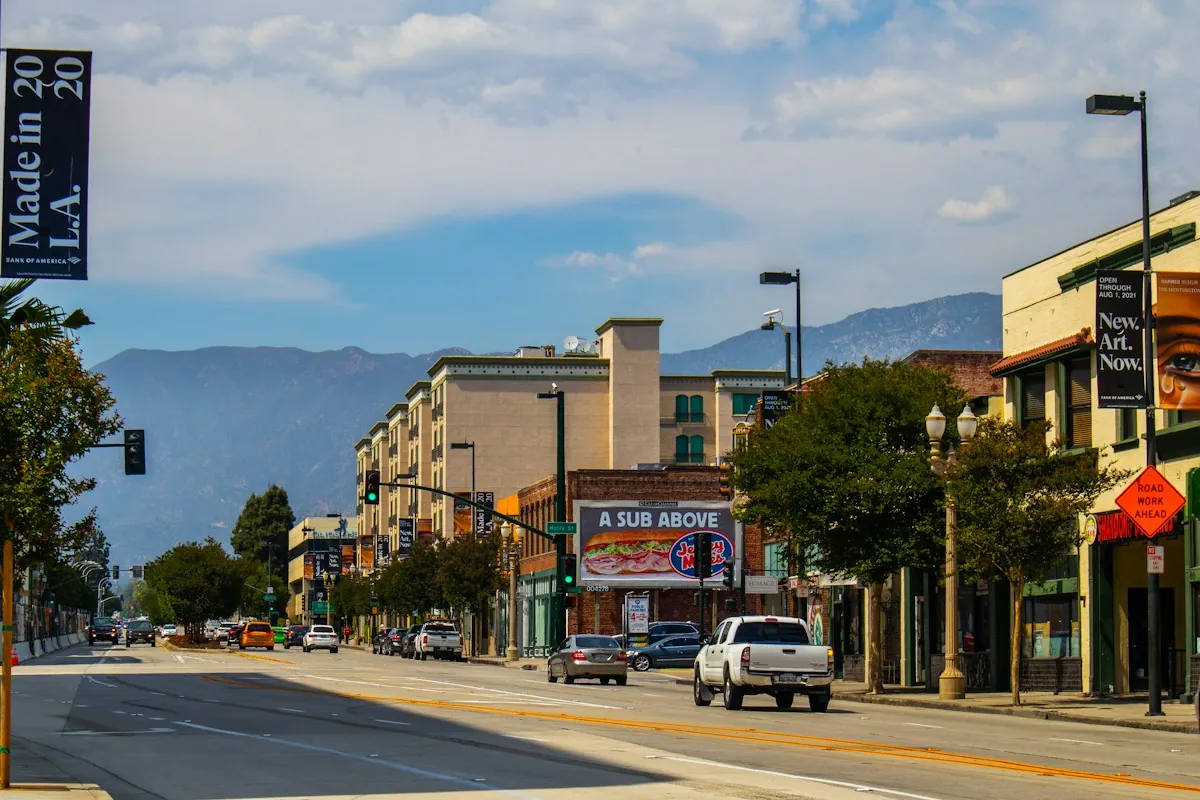 Pasadena street with street trees and the San Gabriel Mountains behind